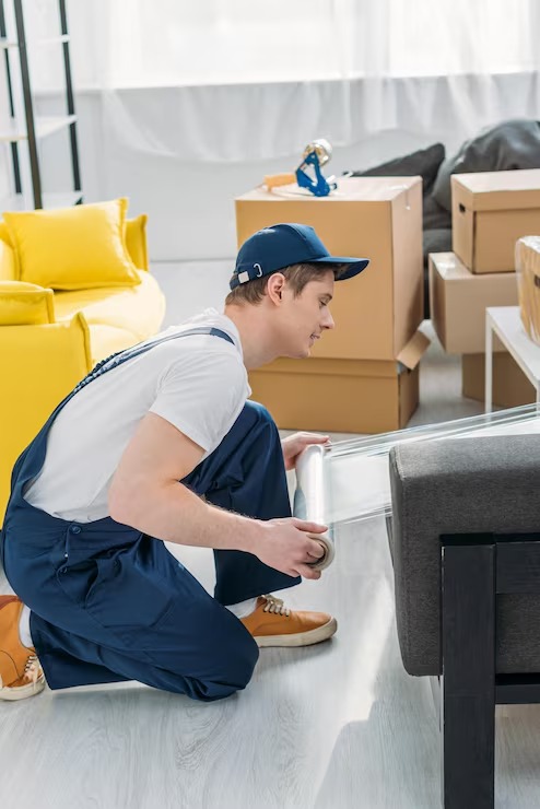 Two movers carrying boxes